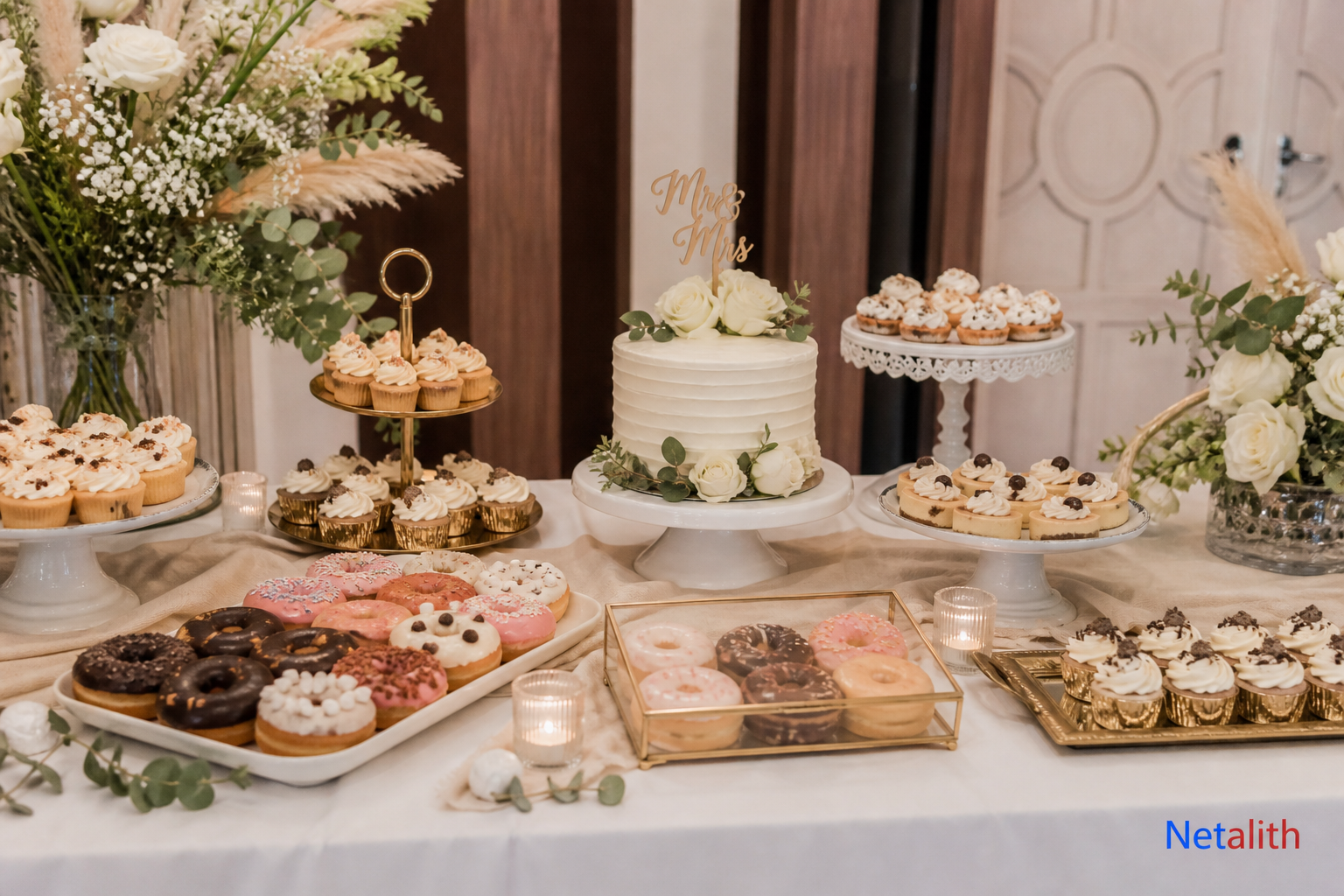 Wedding dessert table with mini cakes and donuts as alternatives to a large formal cake